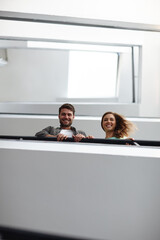 Portrait, smile and people on stairs for architecture designer, building interior and teamwork support. Happy, man and woman with low angle with real estate design, creative industry and development