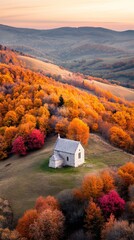Poster - Warm sunlight bathes a picturesque landscape of rolling hills covered in vibrant autumn foliage, with a charming small church nestled amidst the colorful trees, creating a serene and idyllic scene