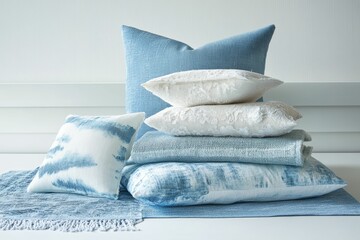 Sticker - Blue and white pillows are stacked on a table.