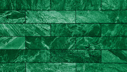 Wall Mural - close-up view of a floor clad in rectangular green slate tiles, a smooth, uniform of marble stone surface with subtle variations in shade and texture, creating a visually appealing modern aesthetic.