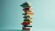 © Kitta Studio - Colorful Stacked Books on Light Blue Background for Education Concept