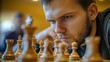 © sambath - A chess player concentrating intensely during a high-stakes game, demonstrating mental endurance and focus.