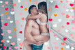 © deagreez - Side view of beautiful obsessed husband and wife, young brunet muscular guy and curly blonde lady in white underwear, are kissing passionately near the window, holding girl under hips