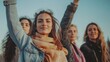 © Visioner - Four Women Friends With Arms Raised Outdoors at Sunset