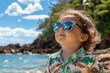 © Moopingz - A stylish toddler in mirrored sunglasses gazes at a tropical sky above a turquoise ocean.