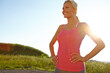 © peopleimages.com - Happy runner, woman and fitness break in road for wellness challenge, marathon training and checking direction. Space, athlete and relax in nature for exercise rest, workout performance and blue sky
