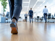 © niwat - This photo captures a modern office space with several blurred figures of business professionals going about their work. The image conveys a sense of movement and activity within the workplace