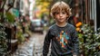 © Iurii - Confident boy in long-sleeve t-shirt walks along a charming brick path in autumn