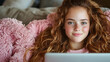 © BROPRADANA - Teen girl relaxing on sofa, using laptop, cozy home