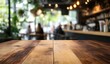 © heri - Wooden Table in a Blurred Cafe Setting