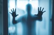Mysterious silhouette behind fogged glass creates an eerie atmosphere of longing and isolation