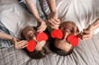 © New Africa - Lovely couple with paper hearts on bed, top view. Valentine's day celebration