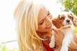 © peopleimages.com - Nature, happy and woman with dog after adoption, puppy care and bonding together with happiness. Outdoor, female person and cavalier pet after rescue for companion, animal and friends with connection