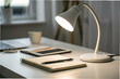 © Butsarakham - Remote Work, Work from home, A cozy workspace featuring a desk lamp, notebook, pen, tablet, and a cup, ideal for studying or creative work.