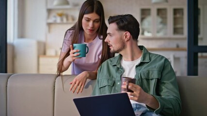 Wall Mural - Family couple drinking tea looking laptop studio closeup. Home pair with coffee