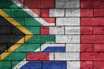 Wall Mural - colourful painted big flag of south africa and flag of peru on a massive old brick wall background. concept