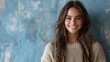 © BlackBird Studio - Smiling Young Woman in Cozy Sweater Against Textured Blue Background