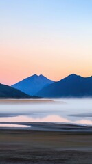 Wall Mural - A mountain range is reflected in the water of a lake. The sky is a beautiful mix of pink and blue hues