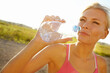 © peopleimages.com - Woman, fitness or drinking water with sunshine in nature for hydration, rest or recovery in countryside. Thirsty, female person or runner with mineral liquid or aqua bottle for natural sustainability