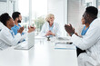 © peopleimages.com - Meeting, applause and group of doctors in office with planning, professional success and medical achievement. Congratulations, cheers and happy people in boardroom with healthcare team at hospital