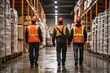 © SY - Three warehouse workers walk down aisle. Image depicts teamwork and logistics in a large distribution center.