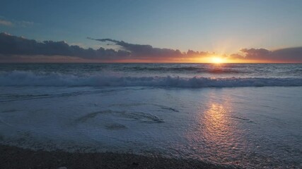 Wall Mural - stunning sunset over sea with vibrant colors reflecting on the water at the beach, 4k