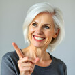 © Gail - middle age white hair woman smiling and looking friendly, showing number four and pointing to the side