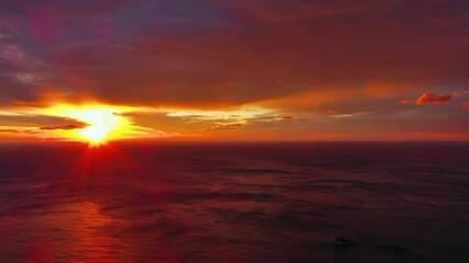 Wall Mural - aerial view of sea surface during a dramatic red sunset, timelapse, 4k
