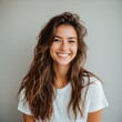 © Fred - Elated woman with messy hair set against neutral background