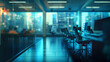 © rizkan - A modern office interior with computers and chairs, illuminated by city lights.