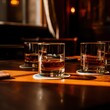 © KenPix - Whiskey glasses, warm amber liquid, dimly lit bar, rich wood surface, golden reflections, cozy atmosphere, crystal-clear glassware, smooth textures, moody lighting, sophisticated ambiance, elegant dri