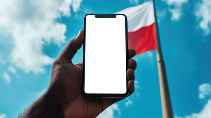 Wall Mural - Black man with a cell phone in his hand against the background of the Polish flag, close-up. A phone mockup for the presentation of a Polish mobile application. Immigration, tourism