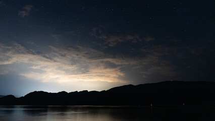 Wall Mural - early morning galaxy visible during early morning with stars above Okanagan lake