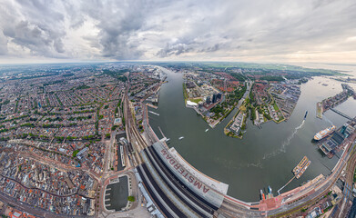 Wall Mural - Amsterdam, Netherlands. Central Railway Station. Panorama of the city on a summer morning in cloudy weather. Aerial view