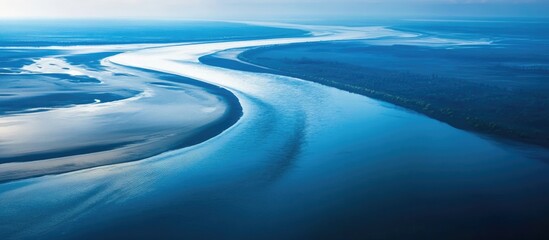 Poster - Aerial view of winding river with reflections on water surface and lush landscape background, Copy Space available