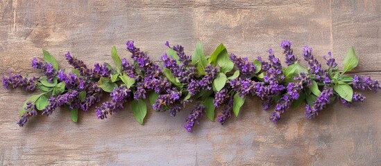 Poster - Purple floral garland on wooden background with leaf accents and ample copy space for text placement.