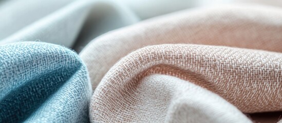 Poster - Textured fabric close-up showcasing soft folds in blue and beige colors with shallow depth of field and Copy Space.