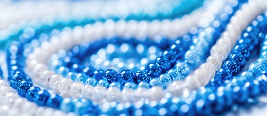 Poster - Blue and white glass beads arranged in a spiral pattern on a light background with Copy Space for text placement