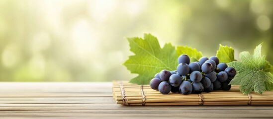 Poster - Fresh grapes with green leaves on a wooden surface with natural bokeh background and copy space for text