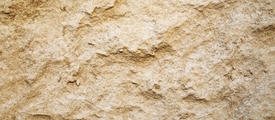 Poster - Rough beige stone wall texture background with natural patterns and weathered surface.