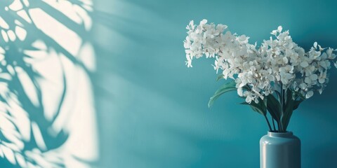 Poster - Elegant blue interior decor featuring floral accents and soft shadows with empty space for text in a modern home setting.