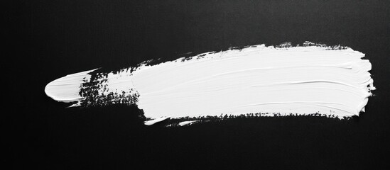 Poster - White paint brush stroke on black background with ample space for customizable text or creative designs
