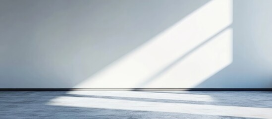 Poster - Empty wall with white light and shadow creating a minimalist space ideal for adding text or design elements for creative projects.