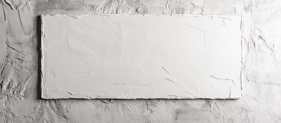 Poster - White plaster frame mounted on textured wall displaying blank area for customizable text or artwork placement.
