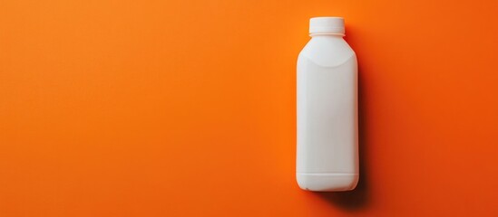 Poster - White plastic bottle on vibrant orange background providing ample empty space for text or branding messages