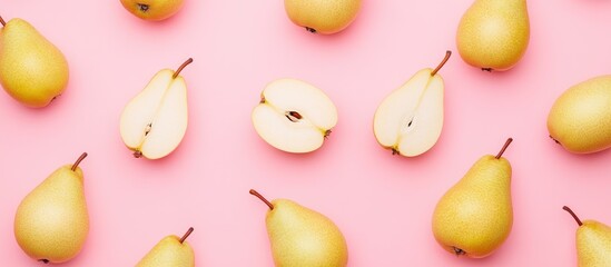 Wall Mural - Fresh whole and sliced pears arranged on a pink background with copy space for text placement