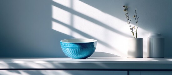 Aufkleber - Blue ceramic bowl on a white shelf with minimalistic vases and sunlight shadows on the wall Copy Space
