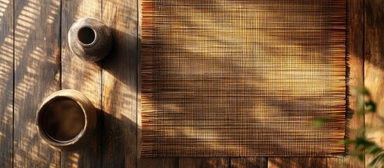 Sticker - Rustic wooden table with woven mat and ceramic vases, natural light casting shadows, Copy Space for text placement