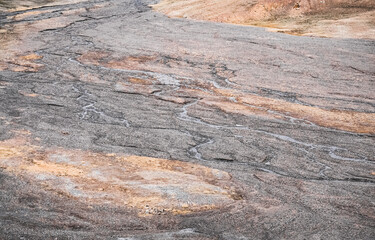 Wall Mural - Mountain river flows in high-mountain Tien Shan among stones in the valley of rocks, riverbed bends in desert landscape among mountains, view from above, landscape for background