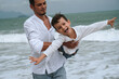 © alexkoral - happy dad with child son playing on the beach by the sea in summer on vacation
